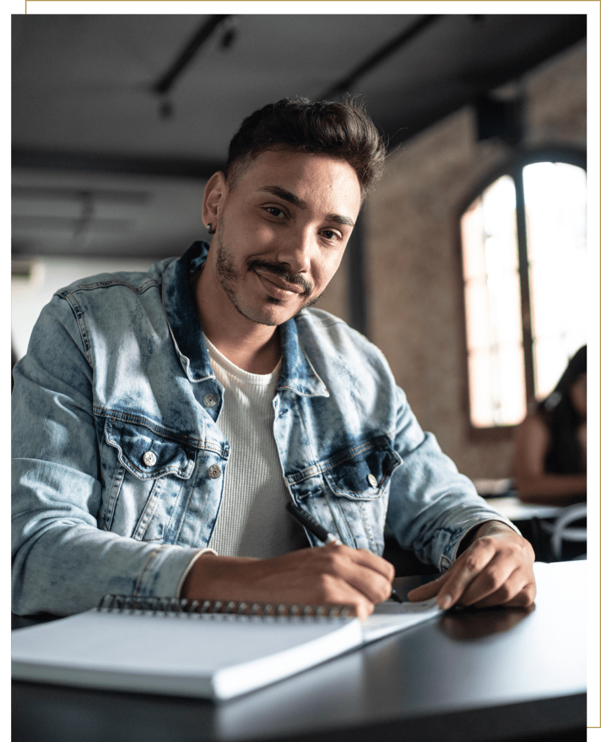 Man in denim jacket writing