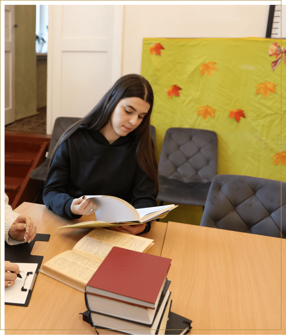Student reading books at a table