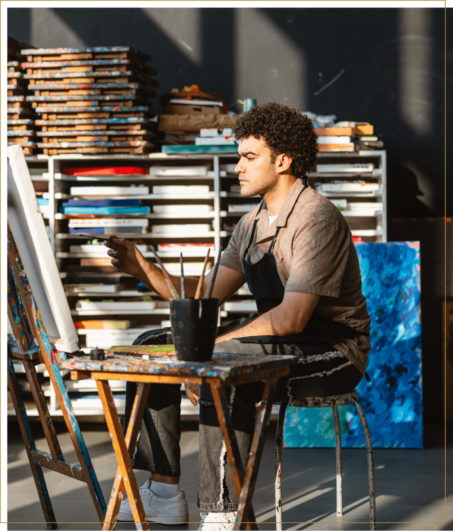 Painter creating art in bright room