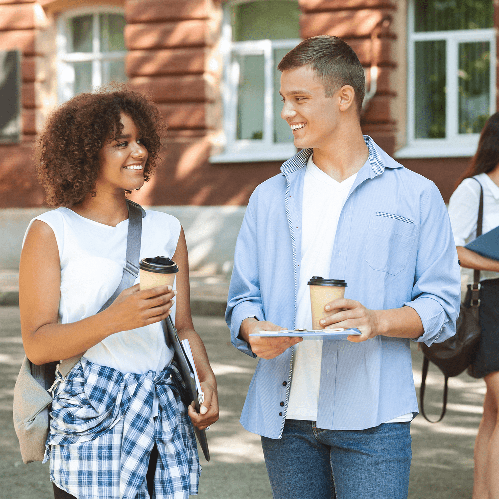 Friends holding coffee cups, smiling